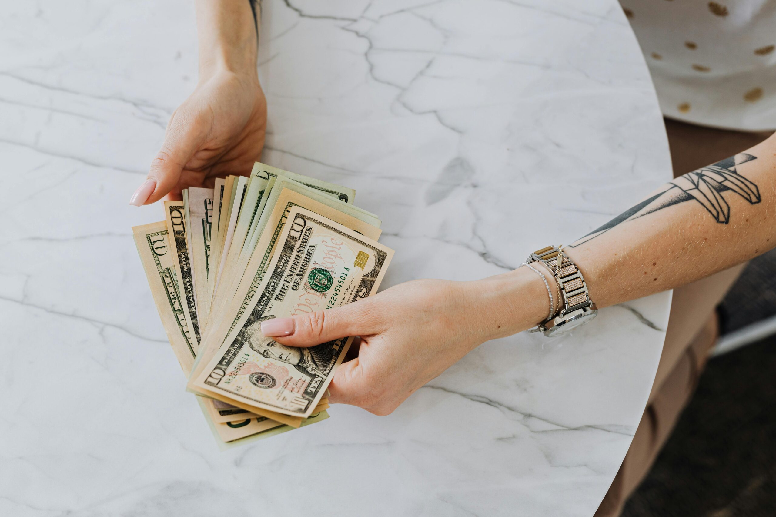 A woman's hands counting money.